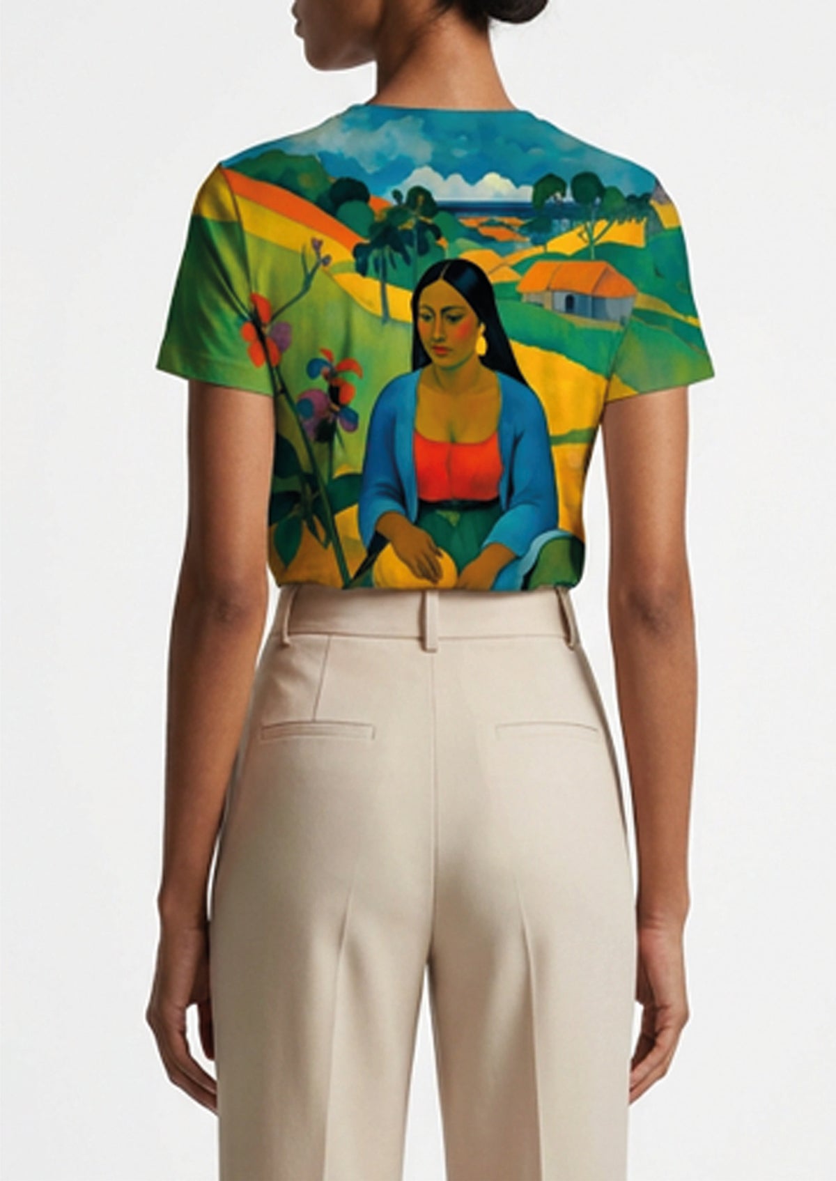 A model shown from the back wearing a short-sleeve crop top with a vibrant, multicolor art print of a seated woman in a landscape, paired with high-waisted cream trousers.